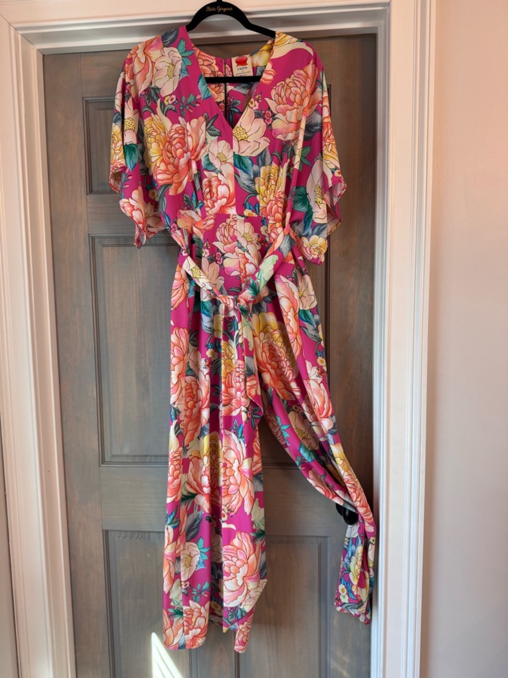 Anthropologie Bright Pink Floral Jumpsuit, with opening in the back.